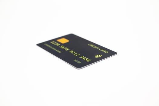 Modern black credit card with gold accents isolated on a clean white background offering a sleek and professional aesthetic photo
