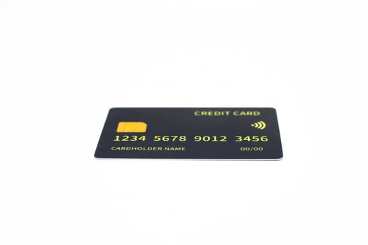 Close-up studio shot of a dark credit card on a white surface, isolated for commercial financial use photo