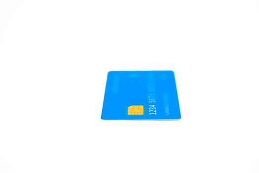 Close-up of a blue credit card on a white background perfect for finance visuals photo