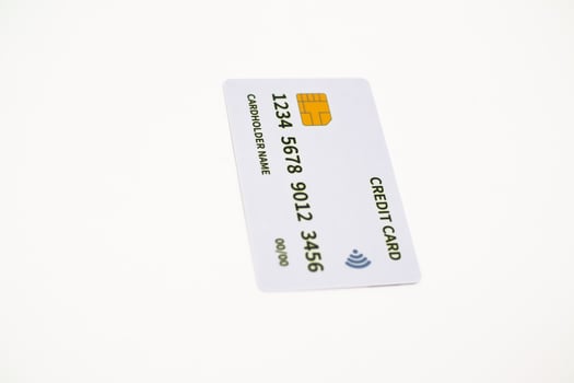 Close-up shot of a white credit card on a white background showcasing modern banking photo