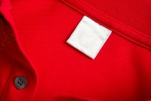 A close up of a red shirt with a white tag photo