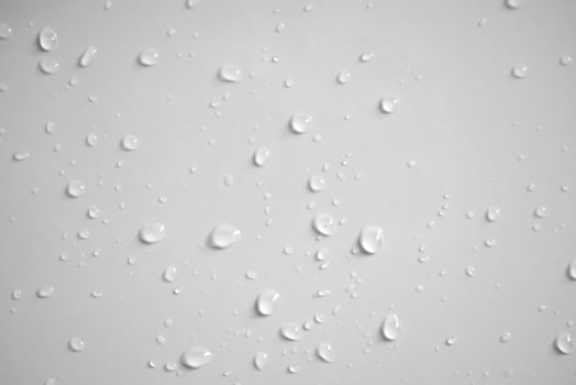 Water drops on the wall, white background photo