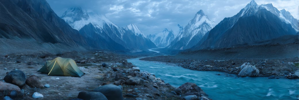 Serene Mountain Landscape with Camping Tent Beside Clear River in Peaceful Wilderness During Twilight Hours photo