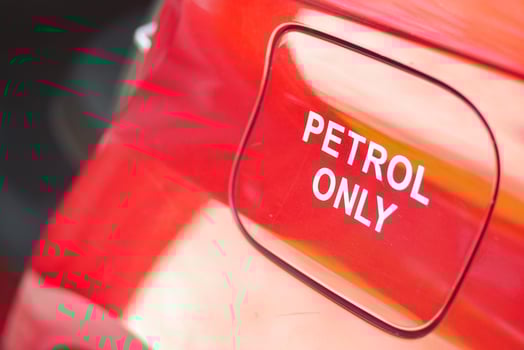 Petrol only warning label on a bright red fuel cap photo