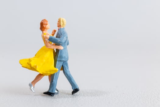 Miniature Couples Dancing on light grey Background photo