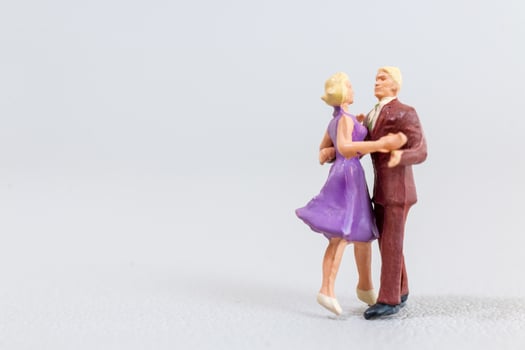 Miniature Couples Dancing on grey Background photo