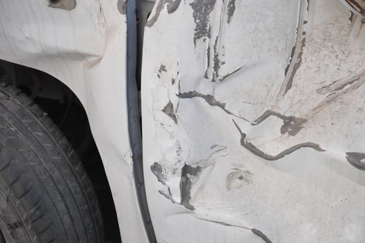 Vehicle damage after a minor collision on city street photo