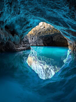 Ethereal Cave Pool Reflecting Natural Light and Stone Formations. photo