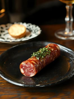 Gourmet Charcuterie Bite with Fresh Herbs and Crusty Bread. photo