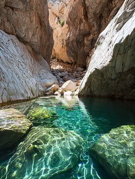 Pristine Turquoise Pool Reflects Sunlight on Rugged Canyon Walls. photo
