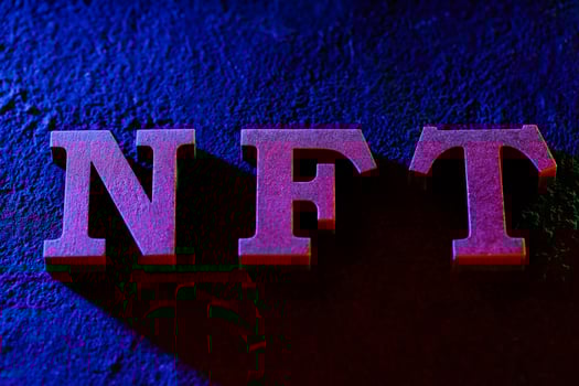 NFT Letters Glowing with Neon Light on Dark Grunge Background photo