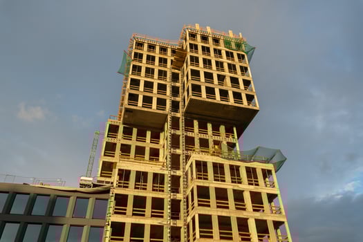 Massive contemporary concrete high-rise building under active construction featuring exposed structural elements, symbolizing urban development, commercial growth, and investment opportunities photo