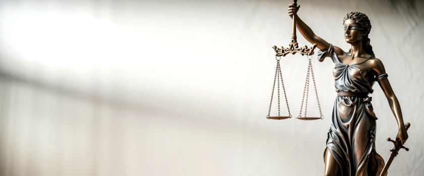 Statue of lady justice holding scales and sword against a soft background photo