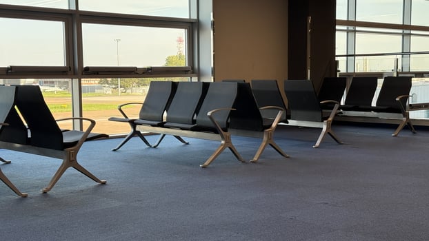Silent airport seats bathe in morning light, echoing journeys untold, perfect for global wanderlust and World Tourism Day photo