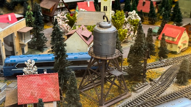 Miniature nostalgic railway village encapsulating serene rural life, model train diorama, intricate detail, evokes National Railway Day and Model Train Enthusiasts Week enchantment photo