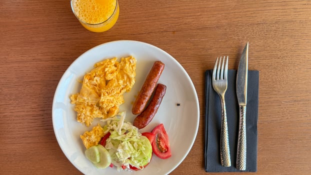 Breakfast medley of scrambled eggs and sausages invites culinary daydreams, hinting at Oktoberfest revelry and lavish brunch tradition photo