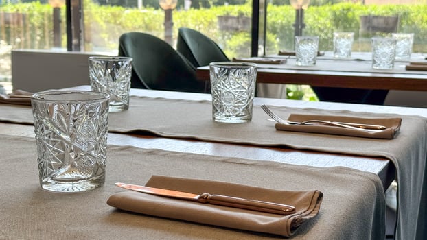 Elegant crystal glasses on linen draped table, serene brunch, mindful dining, World Tableware Day reverie, rustic tranquility photo