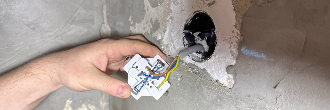 Unlocking electric mysteries, a hand delicately maneuvers tangled wires, evoking Soldering Days intricate dance of circuits and connection photo