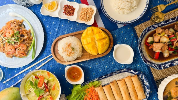 Colorful Thai feast glistening under festive lantern glow, evoking Songkran celebrations, culinary journey of tangy and sweet harmony photo