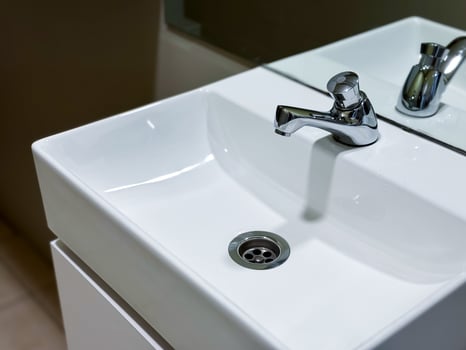 Modern white ceramic sink with chrome faucet in minimalist bathroom setting photo
