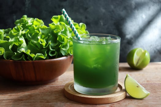 Green vegetable juice glass with fresh veggie. Detox and antioxidants. photo