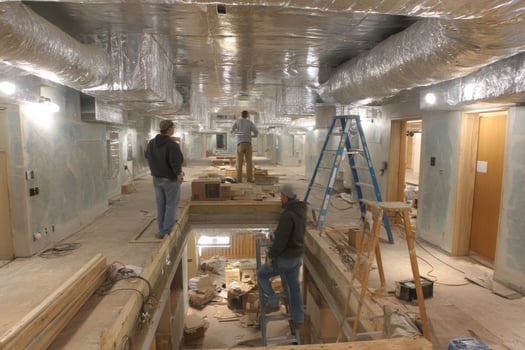Two men are working on a construction project in a hallway photo