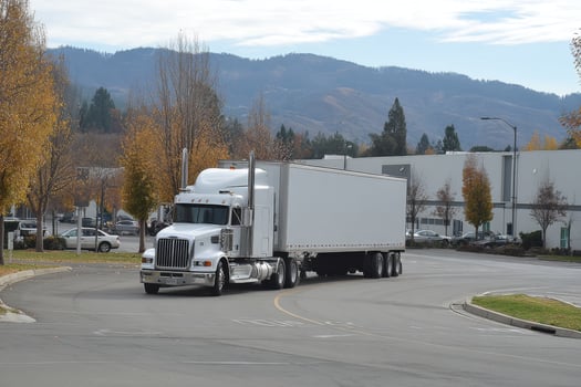 A white truck driving down a street photo