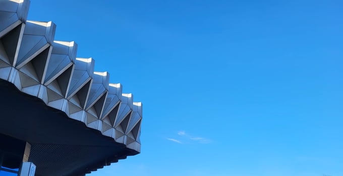 A roof fragment with corners against a blue sky. photo