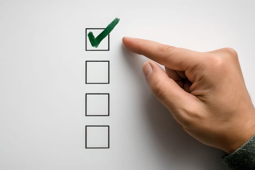 Hand pointing to check list on white background photo