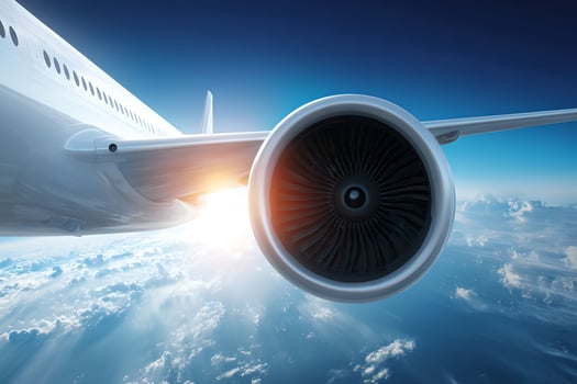 Airplane engine in the sky with clouds and sun photo