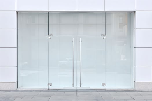 A large white building with glass doors photo
