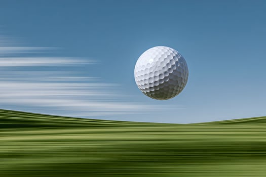 A golf ball flying through the air photo