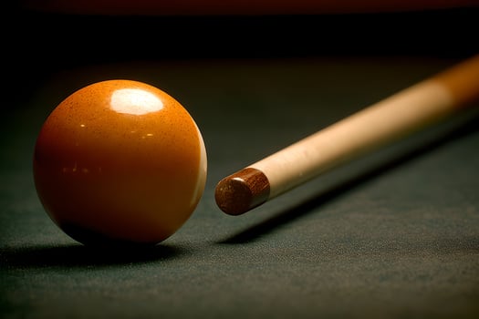 A billiard ball and a wooden stick photo
