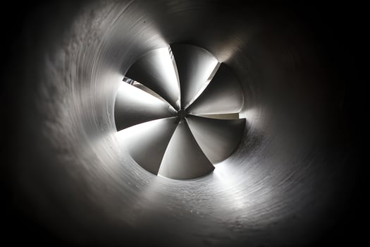 A close up of a metal pipe with a light shining through it photo