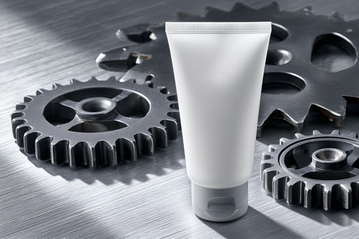 A tube of cream is sitting on top of a metal surface photo