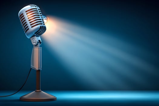 A microphone on a stand with a spotlight photo