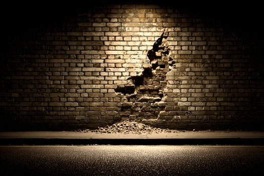 A brick wall with a hole in it at night photo