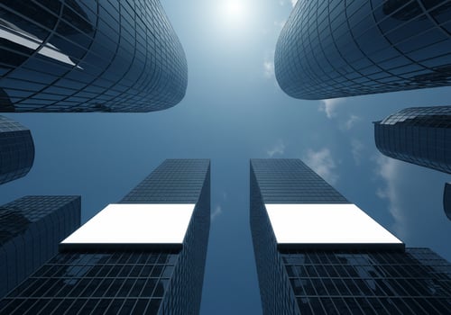 Modern Skyscrapers with Blank White Billboards Against a Bright Blue Sky photo