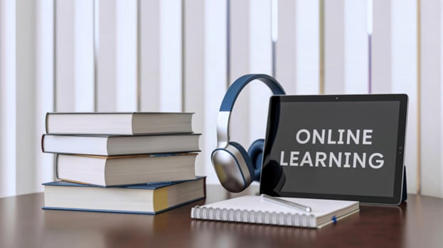 Digital tablet headphones and books for online learning education and study photo