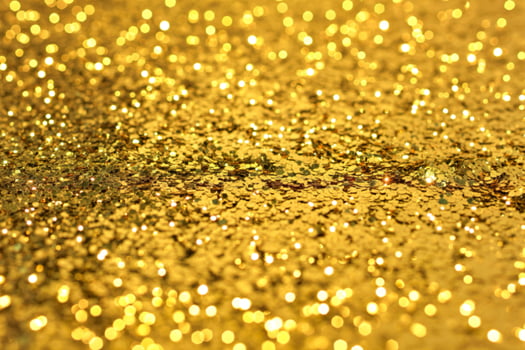 Gold glitter background with sparkles photo
