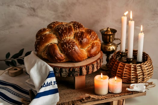 Shabbat challah on a wooden stand, with candles and a rustic bale. Shabbat Shalom photo