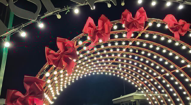A light arch with red bows in the park on New Year's Eve. photo