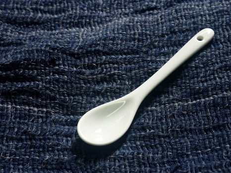 A spoon on a blue cloth photo