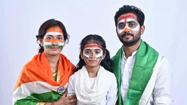 A family with painted faces and indian flags photo