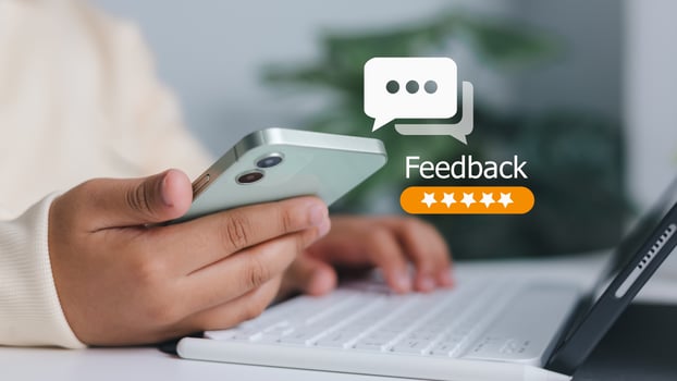 Customer satisfaction, online review, and business service evaluation. Close-up of person holding smartphone with feedback and five-star rating icon. photo