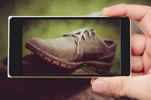 Shoes on smartphone screen. New stylish brown mens shoes. photo