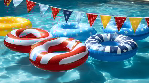 Colorful inflatable rings floating in swimming pool with patriotic garland celebrating independence day photo