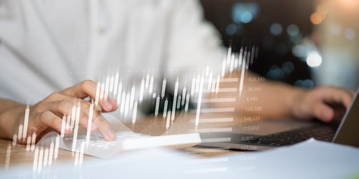 Hands typing on keyboard with transparent stock chart overlay, symbolizing financial technology, real-time market analytics, investment planning, and economic data insights. photo