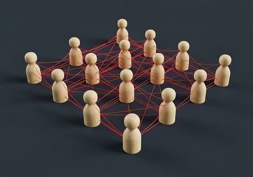 Wooden Figures Connected by Red Lines Showing Network Relationships photo