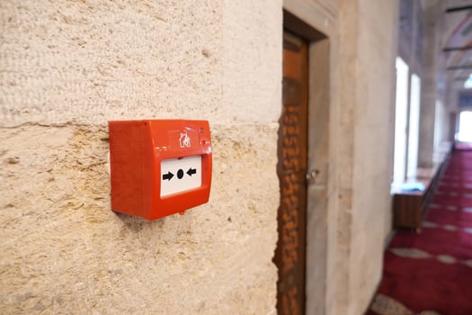 Fire alarm box mounted in a historic building hallway photo